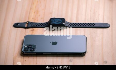 Galle, Sri Lanka - 02 19 2021: Apple iPhone 11 pro max and apple watch series 6 lay flat on a wooden table, luxury and lifestyle concept. Stock Photo