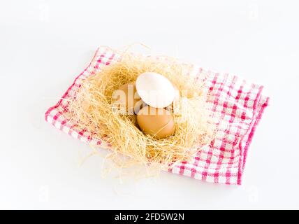 duck eggs and a chicken egg lying on hay. on white background. Stock Photo