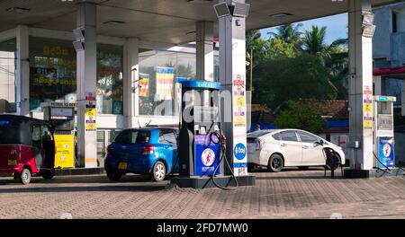 Colombo, Sri Lanka - 03 30 2021: Cars refueling manually in the fuel station in Colombo. Stock Photo