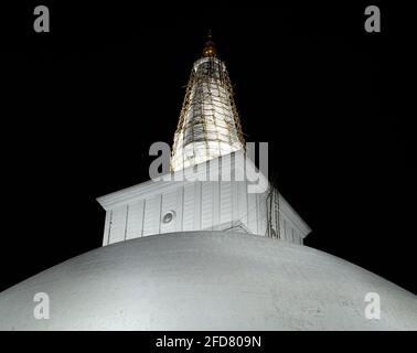 Ruwanwelisaya's stupa glowing in the night, it is a hemispherical structure and containing sacred Buddha's relics built by King Dutugamunu. Stock Photo