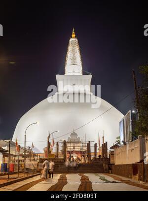 Ruwanwelisaya stupa glowing in the night, it is a hemispherical structure and containing sacred Buddha's relics built by King Dutugamunu. Stock Photo