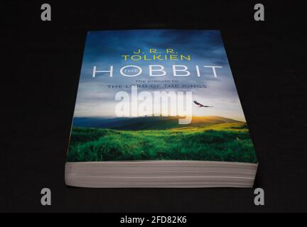 Galle, Sri Lanka - 04 07 2021:The Hobbit by J R R Tolkien, World famous Lord of the rings prelude novel book lay flat in the darkroom tabletop. Fantas Stock Photo