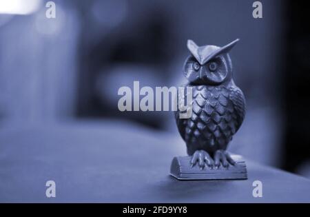 The green form in the form of a small owl created on 3d printer dark background Stock Photo