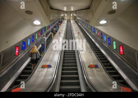 Knightsbridge Station escalators with people on up escalator and down escalator empty, 23 April 2021, Knightsbridge, London Stock Photo