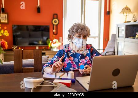 Senior woman consulting with a doctor on her laptop Stock Photo