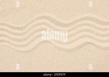 Sandy texture or background, top view of tropical sand with abstract pattern, lines on the sand. Stock Photo
