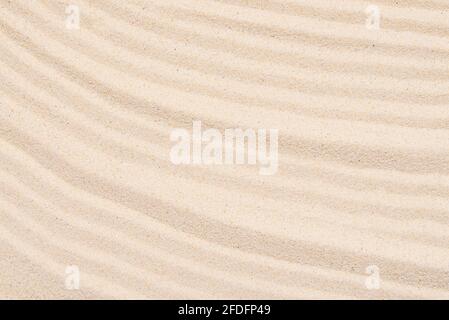 Sandy texture, abstract lines on the top of soft sand, top view, layout Stock Photo