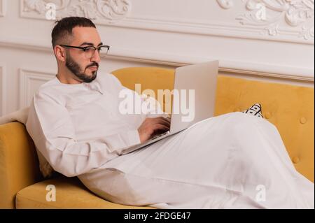 arabic programmer working on laptop at home Stock Photo