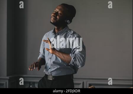 an African American with headphones listening to music and enjoying and slowly dancing Stock Photo