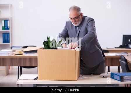 Old employee being fired from his work Stock Photo