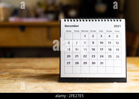 December 2021 calendar - month page showing date on wooden table Stock Photo