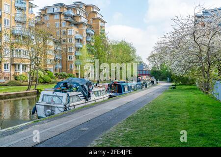 LONDON, UK - APRIL 21, 2021: Narrowboats and houseboats moored on the Grand Union Canal at Little Venice, Maida Vale in west London Stock Photo