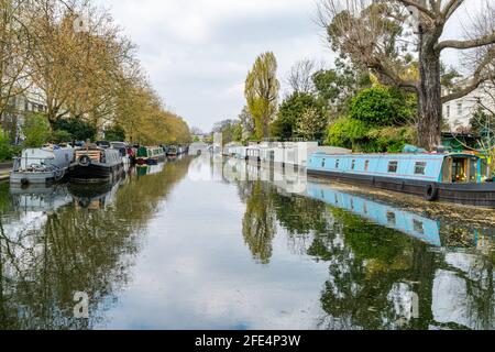 LONDON, UK - APRIL 21, 2021: Narrowboats and houseboats moored on the Grand Union Canal at Little Venice, Maida Vale in west London Stock Photo