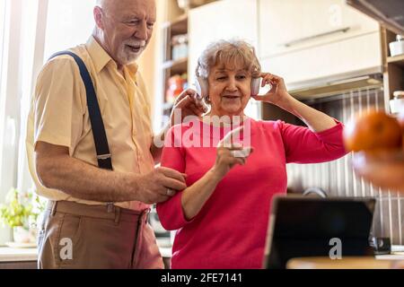 Happy senior couple using digital tablet at home Stock Photo