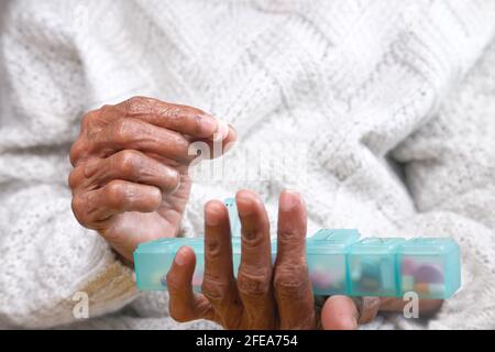 senior women hands taking medicine from a pill box  Stock Photo
