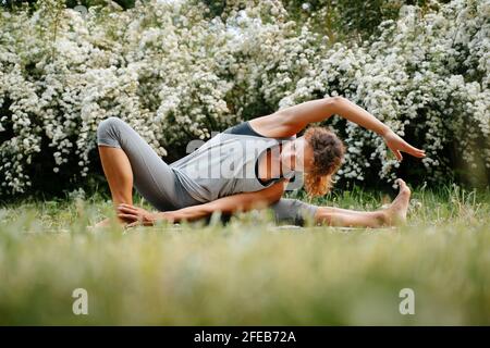 Woman trainer performs yoga poses. Stock Photo