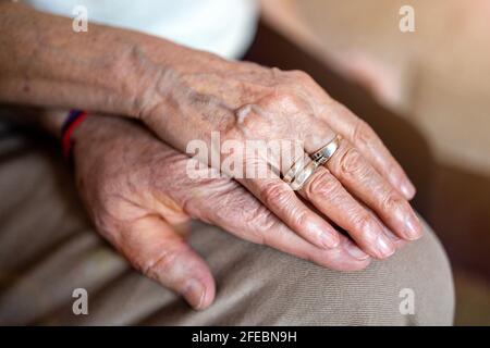 Close up of senior couple holding hands Stock Photo