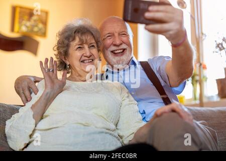 Happy senior couple using digital tablet at home Stock Photo