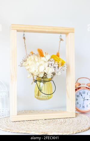 Dried flowers in glass container within a frame as a decoration motif Stock Photo