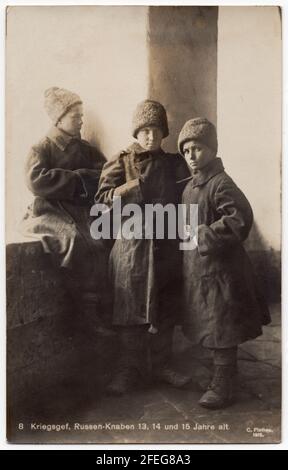 Three Russian boys at age 13, 14 and 15 interned as Russian prisoners of war pictured probably in one of the German POW Camps during the First World War depicted in the black and white vintage photograph by German photographer Karl Plathen from Leipzig dated from 1915. Text in German means: Prisoners of war. Russian boys at age 13, 14 and 15. Courtesy of the Azoor Photo Collection.