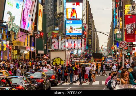 Crowded groups of people crossing the street at Times Square during rush hour Stock Photo