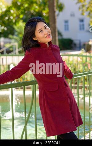 Beautiful chinese woman with long black hair on a sunny autumn day in the city, Stock Photo