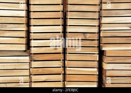 Empty Wooden Boxes Containers Crates for harvest. Stacked storage  boxes from wood on row. Background Stock Photo