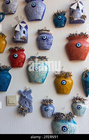 Close up view of colorful wall decoration objects with evil eyes. Reflection of Aegean and Mediterranean cultures capture in famous, touristic Aegean Stock Photo