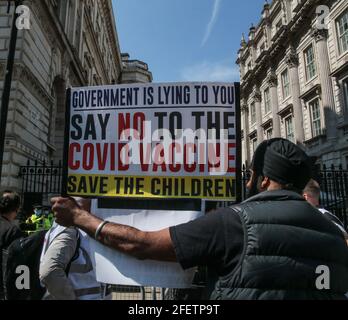 London, UK. 24th Apr, 2021. People from Liverpool come over to had over a petition to ask the government not to vaccinate children, A children then handed the petition over the fences by Downing Street to and officer. Credit: Paul Quezada-Neiman/Alamy Live News Stock Photo