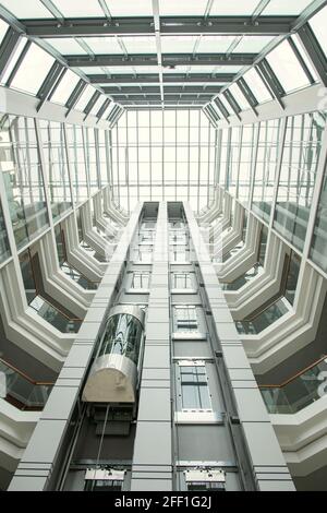 Perspective of office lobby: round-shaped roof and glassy walls in modern hall with elevator Stock Photo