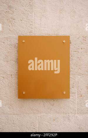 Modern empty rectangular board hanging on stone wall Stock Photo