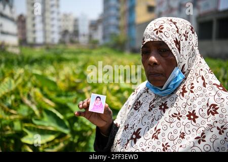 Dhaka, Bangladesh. 24th Apr, 2021. Mother, Nurjahan Begam holds her daughter Selina Begam's picture who went missing, during the eighth anniversary of the Rana Plaza building disaster in Savar.One of the world's most devastating factory disasters, Rana Plaza, an eight story building collapsed due to structural failure and has led to international safety monitoring in Bangladesh, campaigners are warning of “grim consequences” if such oversight is abandoned. Credit: SOPA Images Limited/Alamy Live News Stock Photo