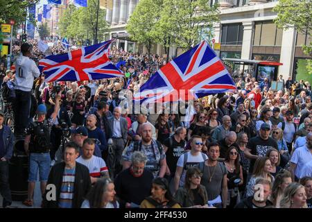 London, UK. 24th Apr, 2021. Protesters march through the Streets while holding flags of the United Kingdom during the demonstration. People called online to a flash mob-style mass gathering against vaccine passport, face masks and lockdown. The government aims to provide official proof of vaccination for millions of British holidaymakers this summer - starting as early as 17 May. (Photo by May James/SOPA Images/Sipa USA) Credit: Sipa USA/Alamy Live News Stock Photo
