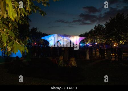 Crowds of people gathering outside Lilas, for the Serpentine summer party. Lilas Pavilion - Serpentine Gallery, London, United Kingdom. Architect: Zah Stock Photo