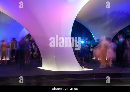 Crowds of people gathering outside Lilas, for the Serpentine summer party. Lilas Pavilion - Serpentine Gallery, London, United Kingdom. Architect: Zah Stock Photo