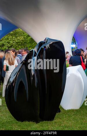 Crowds of people gathering outside Lilas, for the Serpentine summer party. Lilas Pavilion - Serpentine Gallery, London, United Kingdom. Architect: Zah Stock Photo