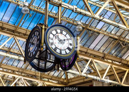 Four-sided Waterloo Station clock manufactured by Gents of Leicester hanging over the concourse, London, UK Stock Photo