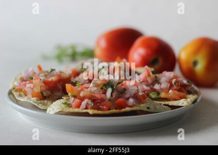 Crisp and fried papads topped with a masala filling of onions, tomatoes and spices. Popular starter from North India commonly known as masala papad. S Stock Photo