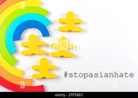 Writing Stop Asian Hate with rainbow on white background. Poster. Violent attacks in schools, businesses, and other public spaces. Stock Photo