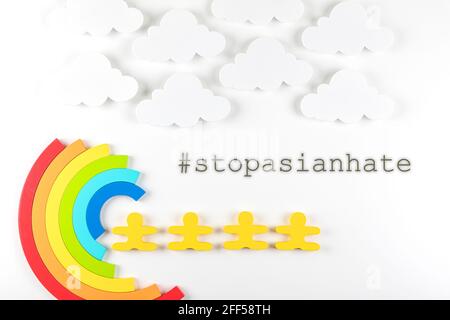 Writing Stop Asian Hate with rainbow on white background. Hate crimes against Asians. Virus has no nationality. Concept of end racism. Stock Photo