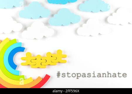 Writing Stop Asian Hate with rainbow on white background. Hate crimes against Asians. Virus has no nationality. Concept of end racism. Stock Photo