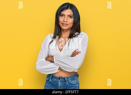 Young latin transsexual transgender woman wearing casual clothes looking to the side with arms crossed convinced and confident Stock Photo
