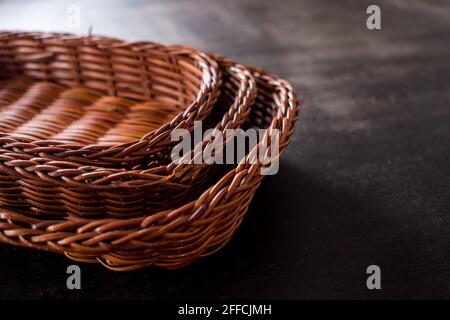 Some brown handmade baskets on a black wooden table Stock Photo