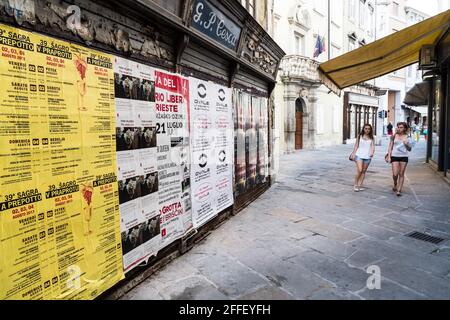 Posters on wall in side street, Trieste, Italy Stock Photo