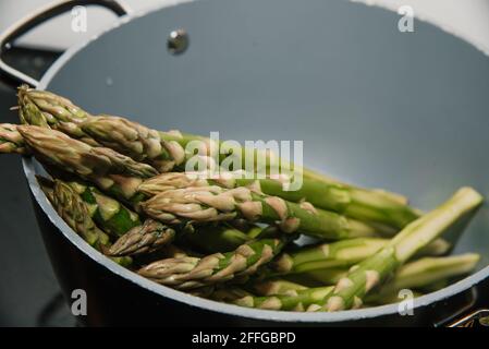 Fresh green seasonal asparagus in a pot ready to cook Stock Photo