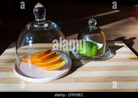 Slices orange and lime in glass container Stock Photo