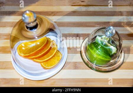 Slices orange and lime in glass container Stock Photo