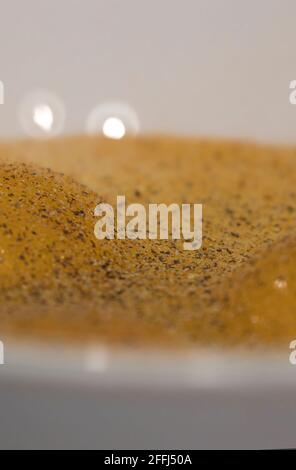 detailed shot of eggs cracked into a white bowl and seasoned Stock Photo