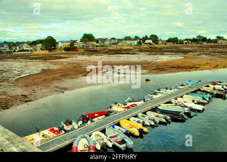 Water crafts are docked on a long pier as the tide is partly out in the Bay of Fundy, in New Brunswick Canada. Stock Photo