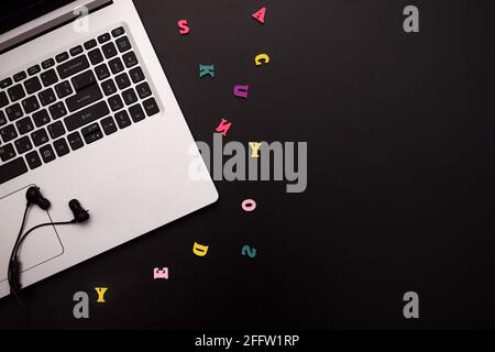 Laptop, headphones, colorful wooden letters.. mock up Stock Photo